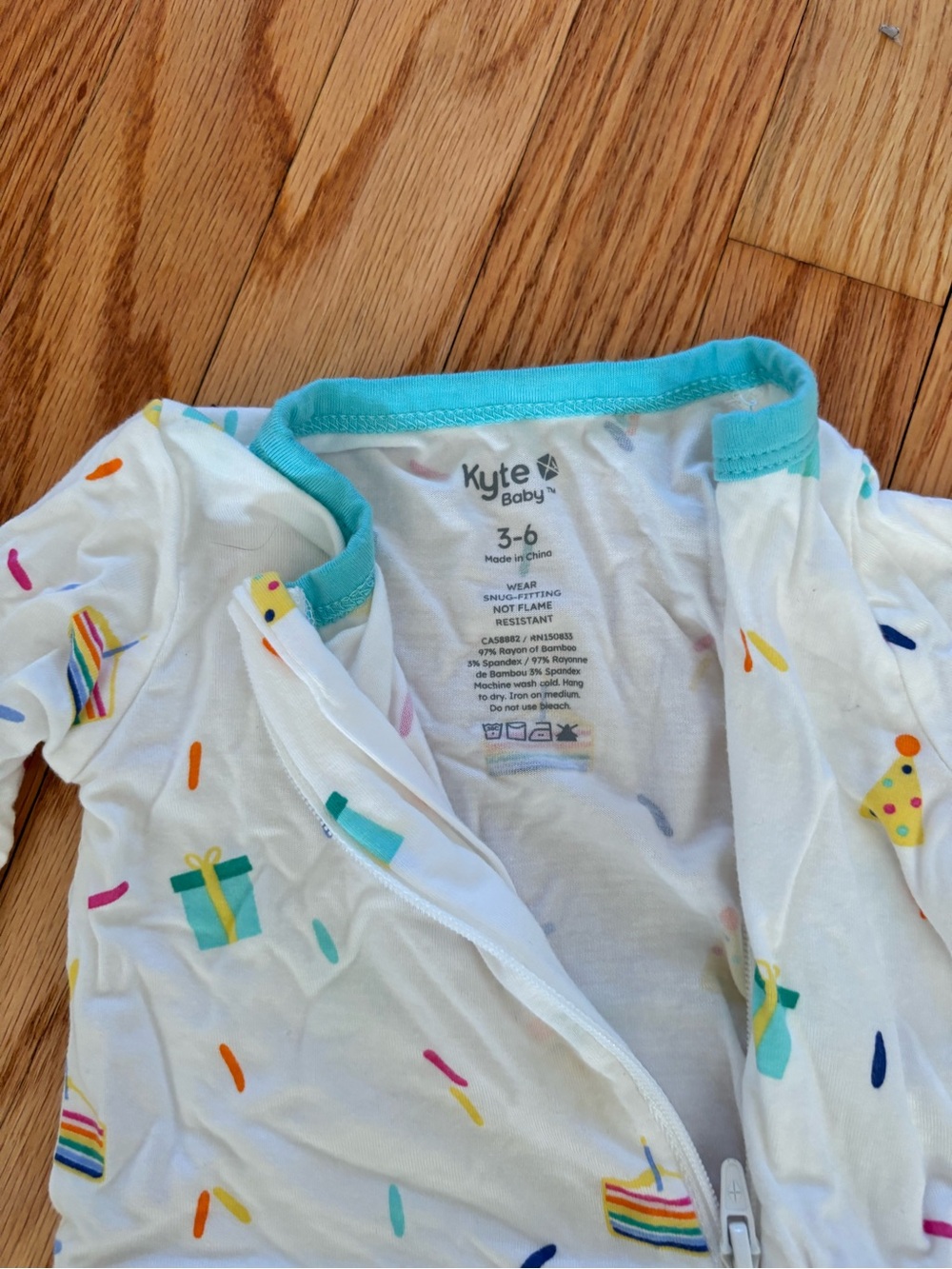 Kyte BABY White Party Print One-Piece Footie with Teal Trim - Picture 2 of 3